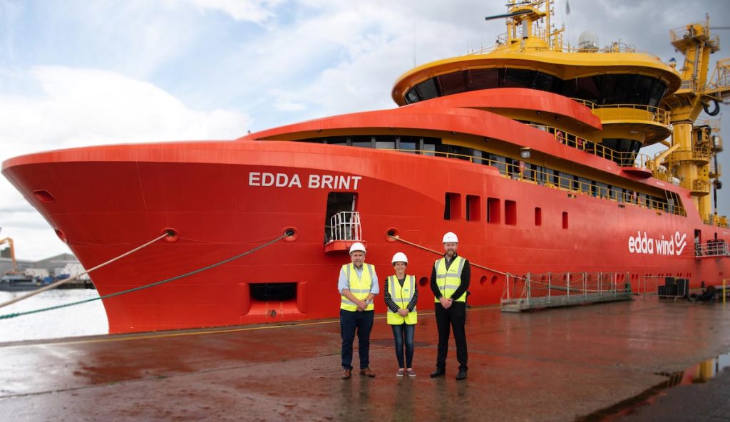 MPA CEO Tom Hutchison with MSP Mairi Gougeon and Niall Murphy from SSEE Renewables in front of the Edda Brint.
