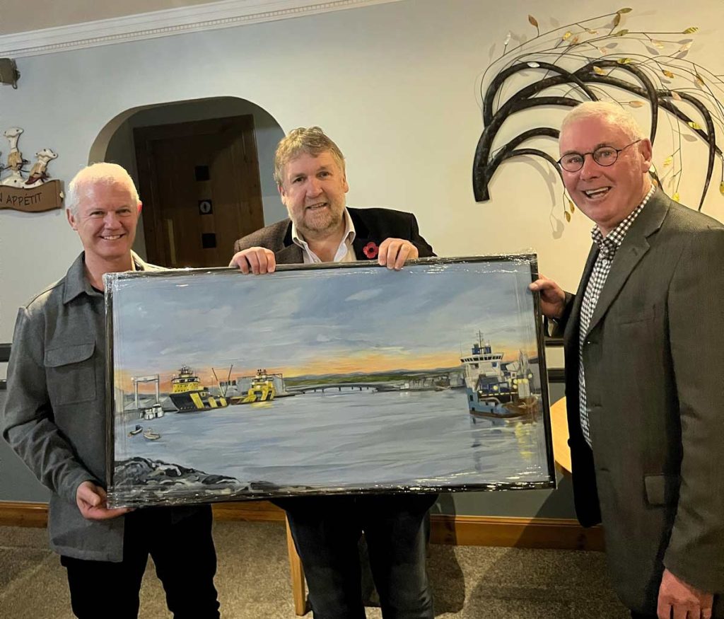 Peter Stuart, Board Chairman of Montrose Port, and Montrose Port CEO, Tom Hutchison, gifting Hamish Watt a painting of Montrose Port at his retirement party