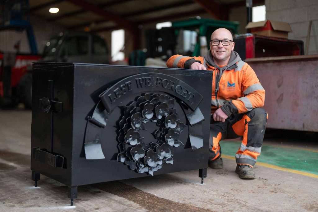 Liam Stewart posing with accessible Remembrance Day planters he fabricated in the Montrose Port Authority workshop, to be placed at Montrose Cenotaph.