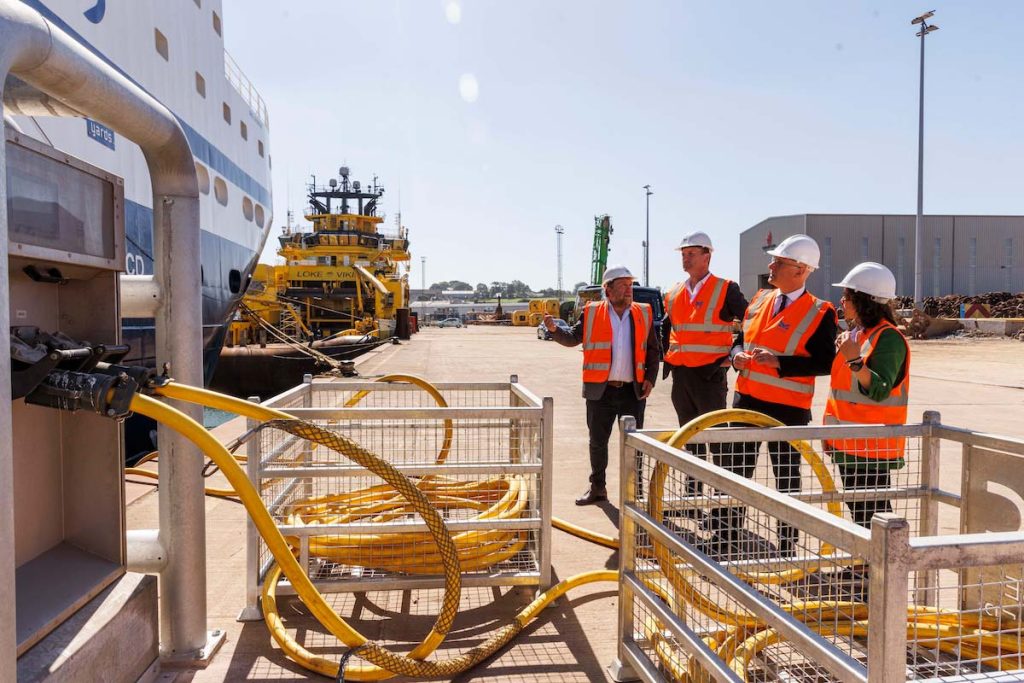 Montrose Port CEO, Tom Hutchison, showing Dave Doogan MP, Scotland's First Minister John Swinney and Mairi Gougeon MSP, the port's shore power facility, Plug Montrose. 