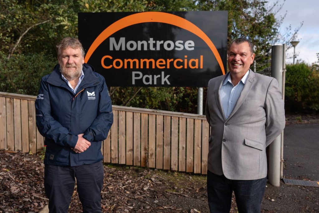 Montrose Port Chief Executive, Tom Hutchison, and Equipco Investments owner, Mark Stephen, standing infront of the Montrose Commercial Park sign at the entrance to the site. 